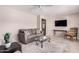 Cozy living room featuring neutral tones, comfortable seating, and a modern ceiling fan at 5633 E Colby St, Mesa, AZ 85205