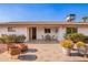 Inviting patio with tiled flooring, seating area, lush plants, and a clear blue sky above at 5633 E Colby St, Mesa, AZ 85205