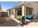 Inviting covered back patio perfect for entertaining, complete with grill and desert landscaping at 5810 E Nora St, Mesa, AZ 85215