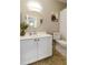Bathroom featuring a round mirror, white vanity, toilet and a ZION national park artwork at 5810 E Nora St, Mesa, AZ 85215