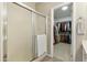 Bathroom featuring a glass shower and a view into the walk-in closet at 5810 E Nora St, Mesa, AZ 85215