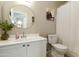Bathroom featuring a round mirror, white vanity, toilet and a ZION national park artwork at 5810 E Nora St, Mesa, AZ 85215