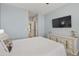 Bright bedroom features light blue walls, a white dresser and a Queen-sized bed at 5810 E Nora St, Mesa, AZ 85215