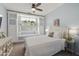Relaxing bedroom features a large window, soft blue walls and a large King-size bed at 5810 E Nora St, Mesa, AZ 85215