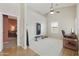 Bonus room with a ceiling fan, a window and an open view to the primary bedroom at 5810 E Nora St, Mesa, AZ 85215
