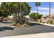 Elegant community entrance with lush landscaping and paved road at 5810 E Nora St, Mesa, AZ 85215