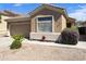 Charming desert home with manicured landscaping and an attached two-car garage at 5810 E Nora St, Mesa, AZ 85215