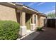 Charming desert home with a green security gate and decorative desert landscaping at 5810 E Nora St, Mesa, AZ 85215