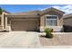 Charming single-story home featuring a well-kept yard and a two-car garage at 5810 E Nora St, Mesa, AZ 85215