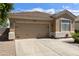 Well-maintained desert home featuring a spacious two-car garage and low-maintenance landscaping at 5810 E Nora St, Mesa, AZ 85215