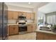 Well-equipped kitchen features a stainless steel range and microwave, plus ample cabinet space at 5810 E Nora St, Mesa, AZ 85215