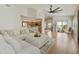 Bright living room with hardwood floors, large sectional, and backyard access at 5810 E Nora St, Mesa, AZ 85215