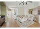 Spacious living room showcasing a large sectional, wood-look floors, and a bright, airy feel at 5810 E Nora St, Mesa, AZ 85215