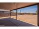 View of the spacious backyard and covered patio area with block fence at 719 E Broadway Ave, Apache Junction, AZ 85119