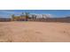 Spacious backyard with a block fence and wooden gate for privacy at 719 E Broadway Ave, Apache Junction, AZ 85119