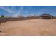 Large backyard surrounded by a tall block fence offers privacy at 719 E Broadway Ave, Apache Junction, AZ 85119