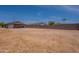 Large, private backyard features a block fence and is ready for landscaping at 719 E Broadway Ave, Apache Junction, AZ 85119