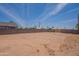Expansive backyard surrounded by a block fence with desert landscaping potential at 719 E Broadway Ave, Apache Junction, AZ 85119