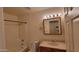 This bathroom features a shower-tub combo and a vanity with marble countertops at 719 E Broadway Ave, Apache Junction, AZ 85119
