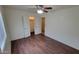 Bright bedroom featuring wood floors, ceiling fan, and double closets for ample storage at 719 E Broadway Ave, Apache Junction, AZ 85119