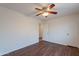Bedroom featuring dark vinyl wood floors, a ceiling fan, and neutral colored walls at 719 E Broadway Ave, Apache Junction, AZ 85119