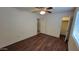 Bedroom featuring wood-look floors, a ceiling fan, and access to a closet at 719 E Broadway Ave, Apache Junction, AZ 85119
