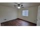 Bedroom with wood-look floors, a ceiling fan, and a window dressed with horizontal blinds at 719 E Broadway Ave, Apache Junction, AZ 85119