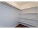 Walk-in closet featuring shelving and a hanging rod for optimal storage solutions at 719 E Broadway Ave, Apache Junction, AZ 85119
