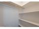 Walk-in closet featuring shelving and a hanging rod for organized storage space at 719 E Broadway Ave, Apache Junction, AZ 85119