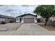 Charming home featuring a two-car garage, desert landscaping, and a cozy covered entry at 719 E Broadway Ave, Apache Junction, AZ 85119