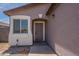 Close-up of the front door with sidelight windows, accentuating the entryway and curb appeal at 719 E Broadway Ave, Apache Junction, AZ 85119