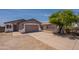 Single-story home with a 2-car garage, xeriscaped yard and a driveway, perfect for low-maintenance living at 719 E Broadway Ave, Apache Junction, AZ 85119