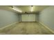 Spacious garage with overhead lighting and ample room for parking and storage at 719 E Broadway Ave, Apache Junction, AZ 85119