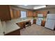 This kitchen features a white refrigerator, lots of cabinet space, and laminate countertops at 719 E Broadway Ave, Apache Junction, AZ 85119