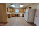 Well-lit kitchen equipped with a white refrigerator, ample cabinet space, and laminate countertops at 719 E Broadway Ave, Apache Junction, AZ 85119