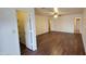 Spacious living room with wood-look floors and multiple doorways at 719 E Broadway Ave, Apache Junction, AZ 85119