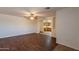 Inviting living room featuring wood-look flooring, neutral walls, and an arched opening to the kitchen at 719 E Broadway Ave, Apache Junction, AZ 85119