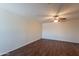 Bright, open living area with wood-look floors and a ceiling fan, offering a comfortable and stylish space at 719 E Broadway Ave, Apache Junction, AZ 85119