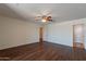 Large living room with wood-look floors and ceiling fan, offering versatile layout options at 719 E Broadway Ave, Apache Junction, AZ 85119