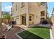 Backyard showcasing artificial turf, pavers, a covered patio and a privacy fence at 732 W Flintlock Way, Chandler, AZ 85286