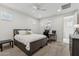 Neutral bedroom with a ceiling fan, carpet flooring, a grey bed frame, and two windows at 732 W Flintlock Way, Chandler, AZ 85286