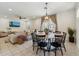 Dining area with a round table with six chairs, pendant lighting, and access to the backyard at 732 W Flintlock Way, Chandler, AZ 85286
