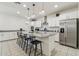 Kitchen featuring white cabinetry, stainless steel appliances, tile backsplash, and a large center island at 732 W Flintlock Way, Chandler, AZ 85286