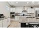 Bright kitchen with granite countertops, stainless steel appliances, and white cabinets at 732 W Flintlock Way, Chandler, AZ 85286