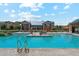 Community pool featuring ample lounge seating, umbrellas, and a clubhouse in a beautiful outdoor setting at 732 W Flintlock Way, Chandler, AZ 85286