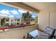 Relaxing balcony with views of the pool, lush greenery, and community buildings at 750 E Northern Ave # 2143, Phoenix, AZ 85020