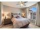 Serene bedroom boasts a large arched window, neutral tones, and comfortable furnishings, creating a relaxing retreat at 750 E Northern Ave # 2143, Phoenix, AZ 85020