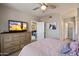 A tranquil bedroom features a view to the en-suite bathroom and a large television at 750 E Northern Ave # 2143, Phoenix, AZ 85020