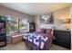 A light-filled bedroom features a large window, a quilt-covered bed, and ample storage at 750 E Northern Ave # 2143, Phoenix, AZ 85020
