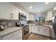 Bright kitchen with stainless steel appliances, white cabinets, and gray subway tile backsplash at 750 E Northern Ave # 2143, Phoenix, AZ 85020